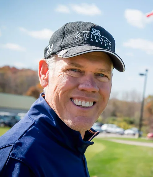 Jay Delsing on the golf course, smiling, wearing a Krilogy golf cap